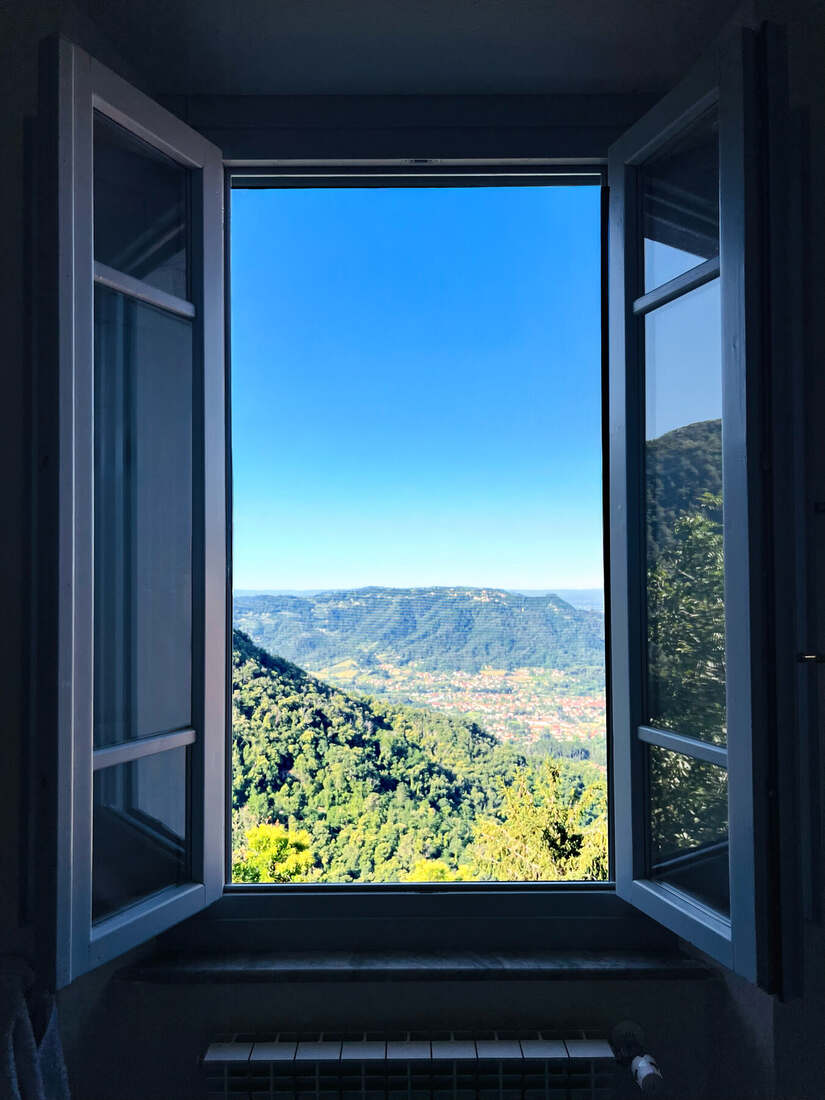 View through an open window across the valley