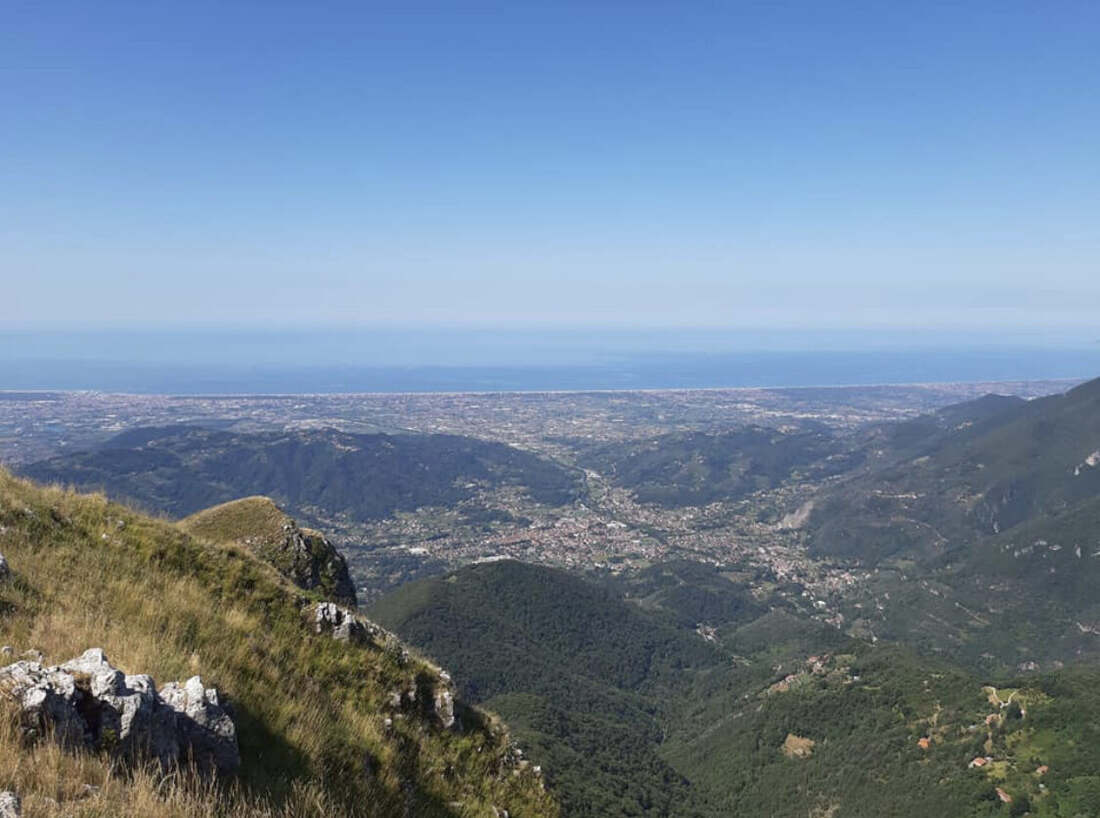 View from the mountain summit across the valley to the sea