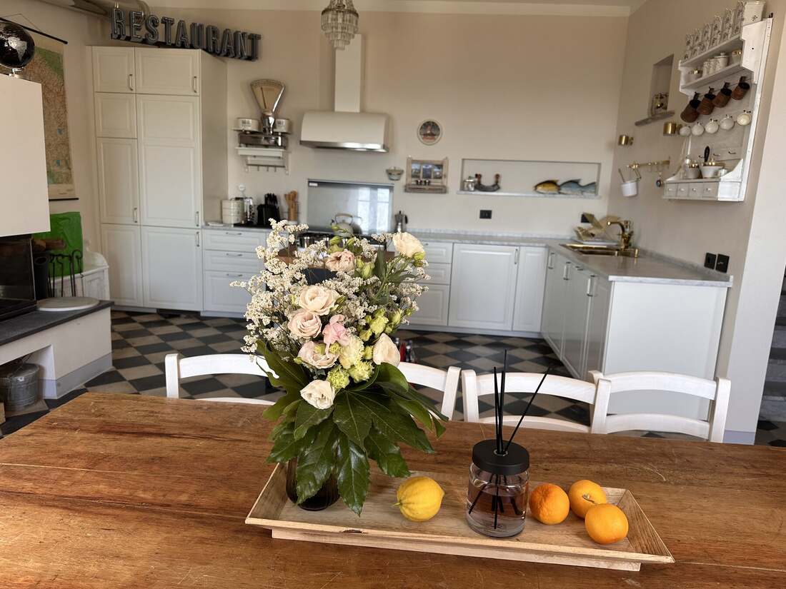 Kitchen table styled with flowers and fresh fruit